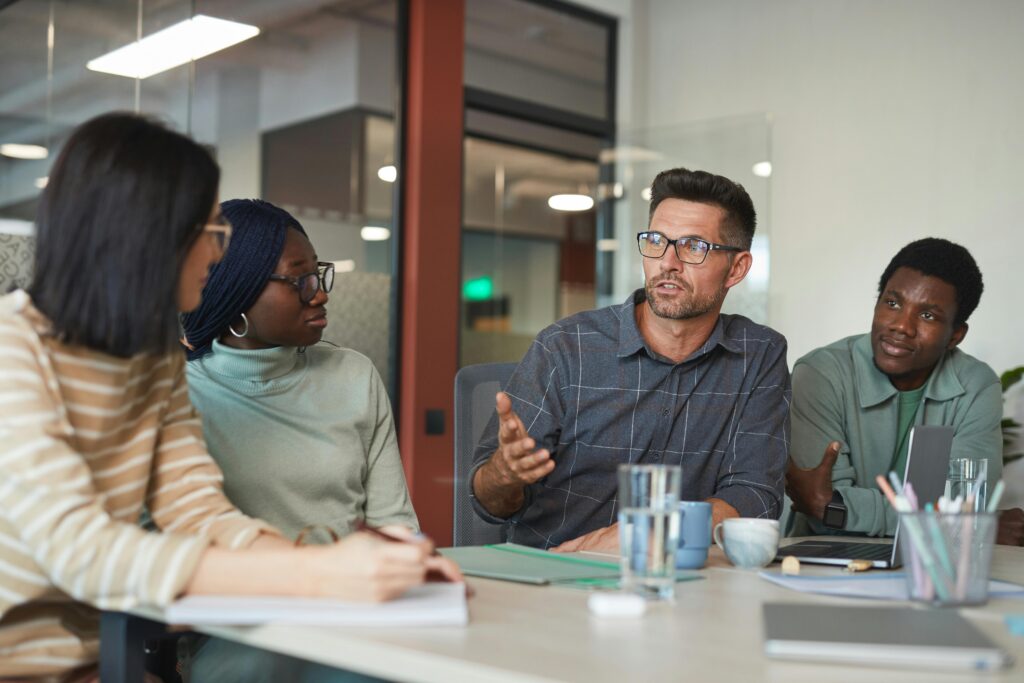 A man talking to his colleagues.